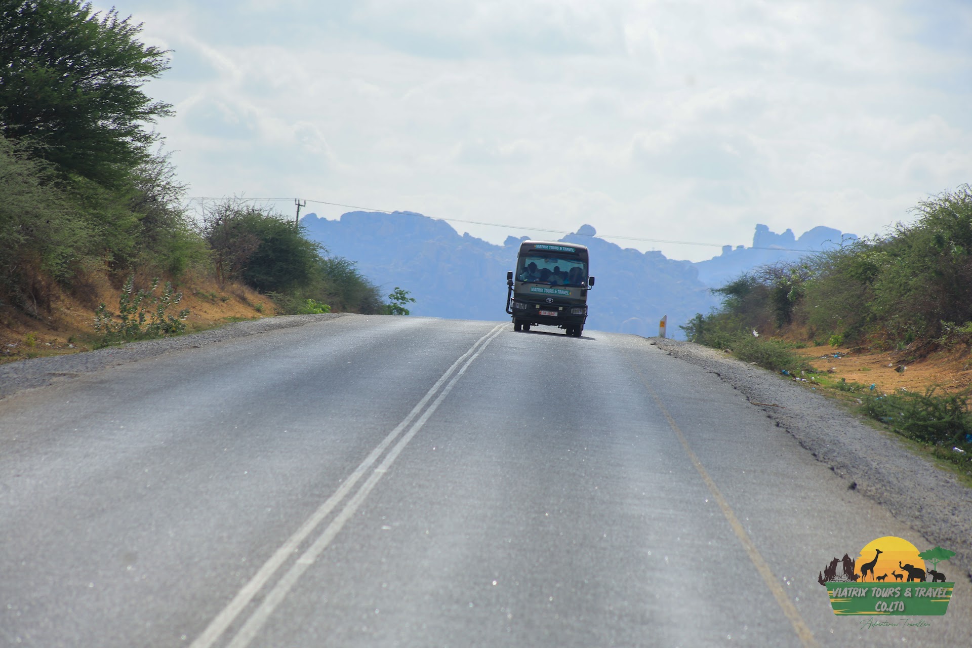 Viatrix tour vehicle traveling through a mountain landscape