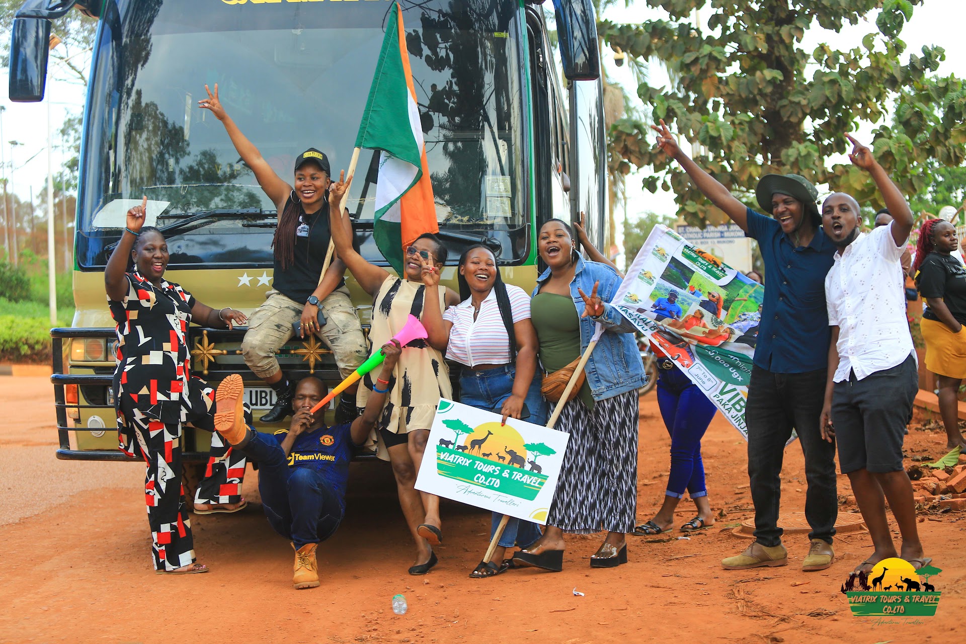 Viatrix travelers celebrating in front of a tour coach