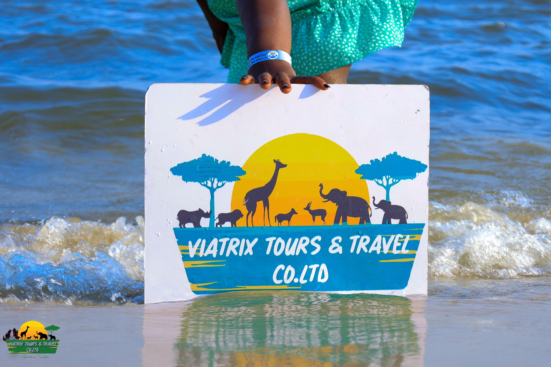 Viatrix Tours and Travel sign beside the water